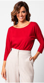 Woman wearing Eva Classic Top in Scarlet Red with three-quarter sleeves paired with light beige trousers against white background