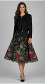 Woman wearing Frida Cropped Zip Blazer in Black styled with floral midi skirt and black heels on gray background