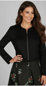 Woman wearing Frida Cropped Zip Blazer in Black with long sleeves and a subtle zip front closure.