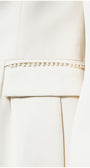 Close-up of pearl embellishment detail on Agatha Pearl Detail Blazer in Ivory pocket trim and tailored fabric