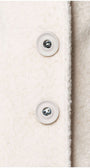 Close-up of button detail on the Linea Belted Midi Coat in Ivory showcasing its soft textured fabric and craftsmanship