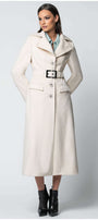 Woman wearing Linea Belted Midi Coat in Ivory with a structured silhouette and statement belt standing against a neutral background