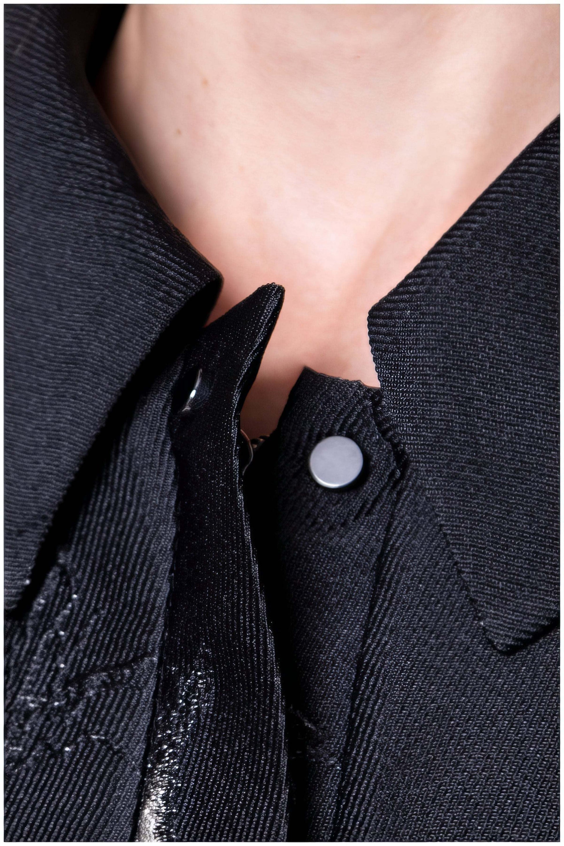 Close-up of black textured fabric and silver button details on the Emma Light Coat with Silver Floral Jacquard collar area