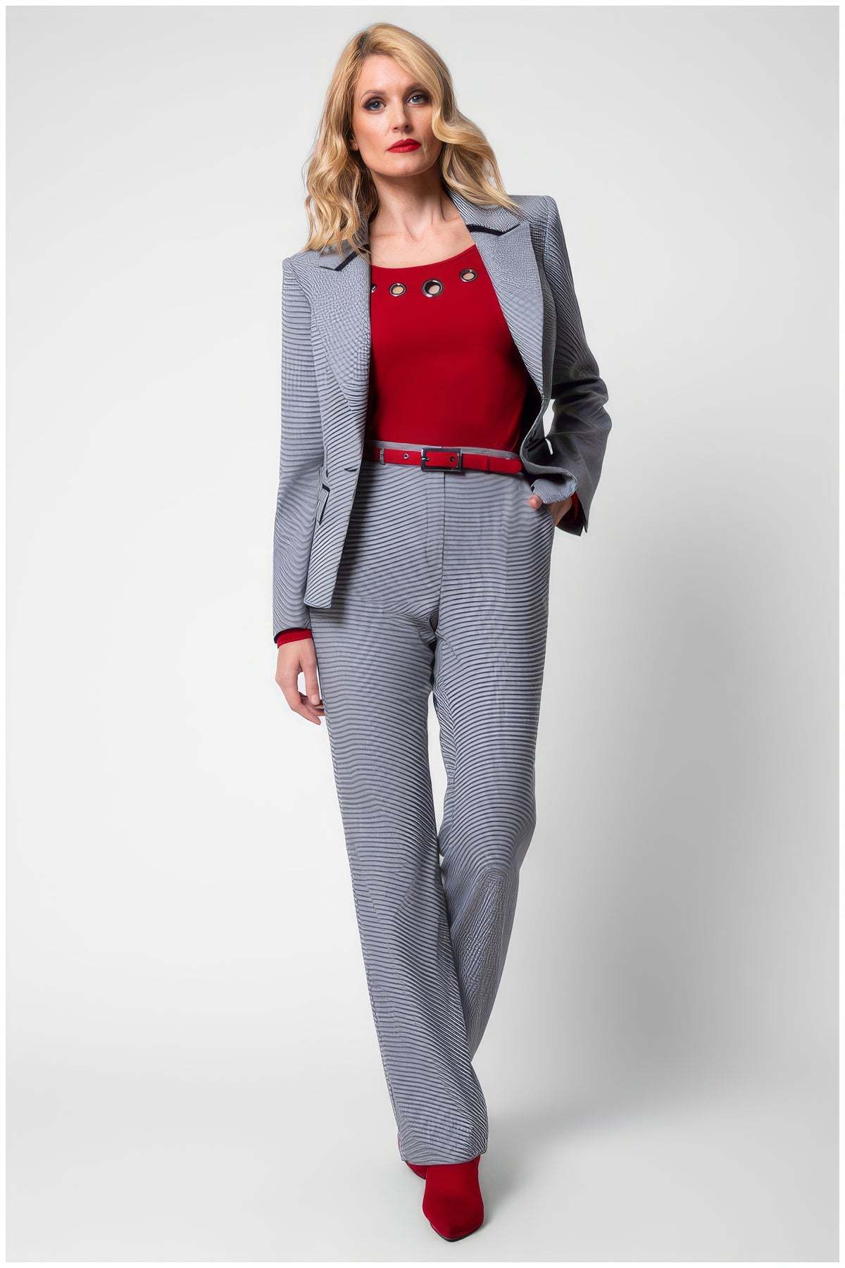 Woman wearing Elena Houndstooth Tailored Blazer paired with matching pants and red top showcasing modern elegance.