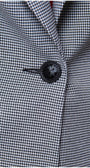 Close-up of black button and patterned fabric on Elena Houndstooth Tailored Blazer from Luna Fashion House collection