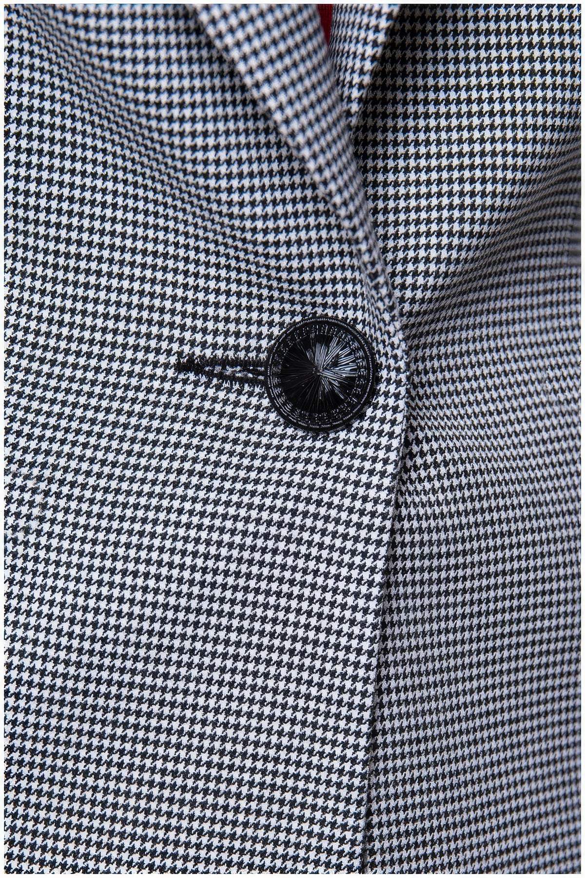 Close-up of black button and patterned fabric on Elena Houndstooth Tailored Blazer from Luna Fashion House collection