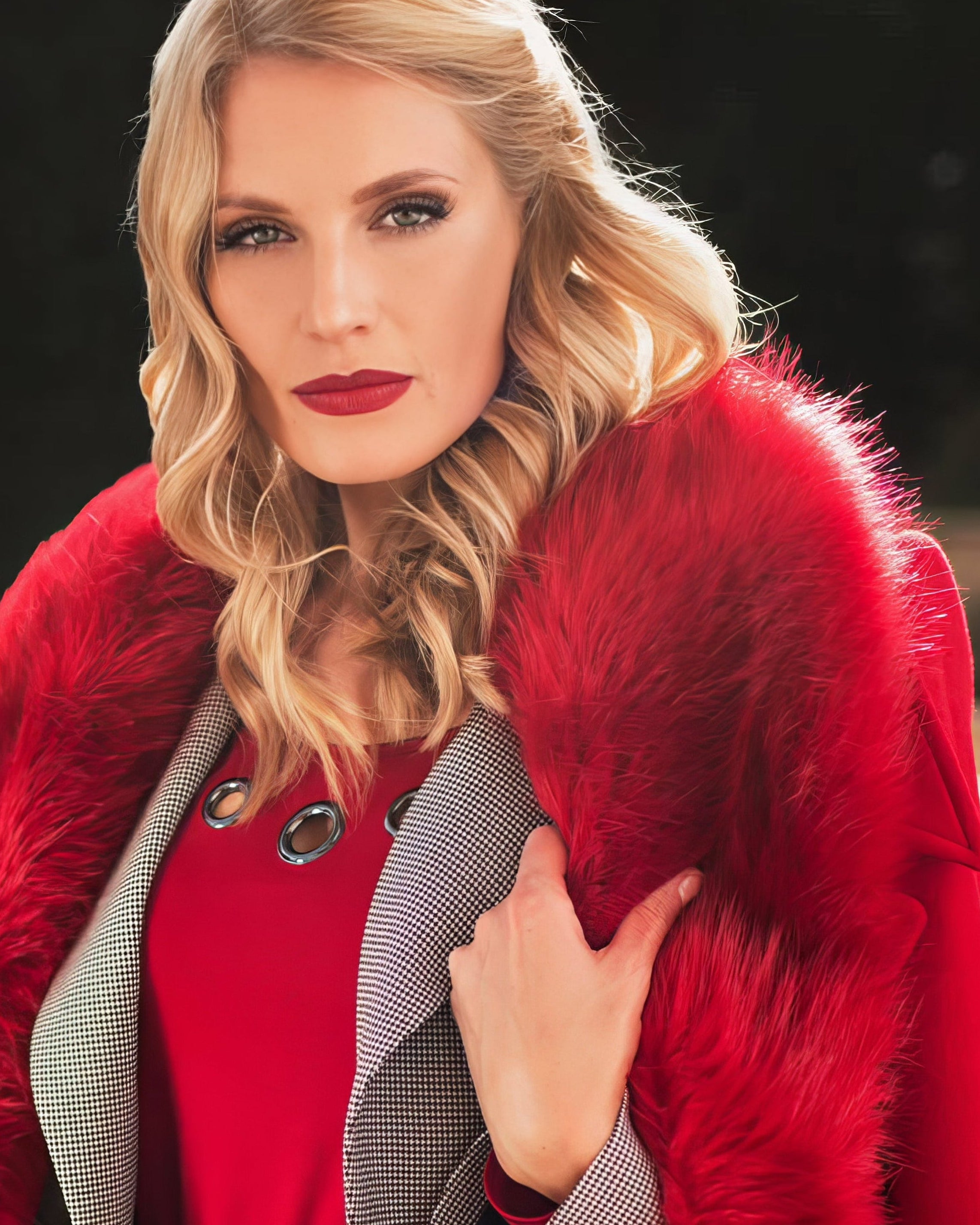 Woman wearing a red Luna Fashion House coat with a fur collar outdoors