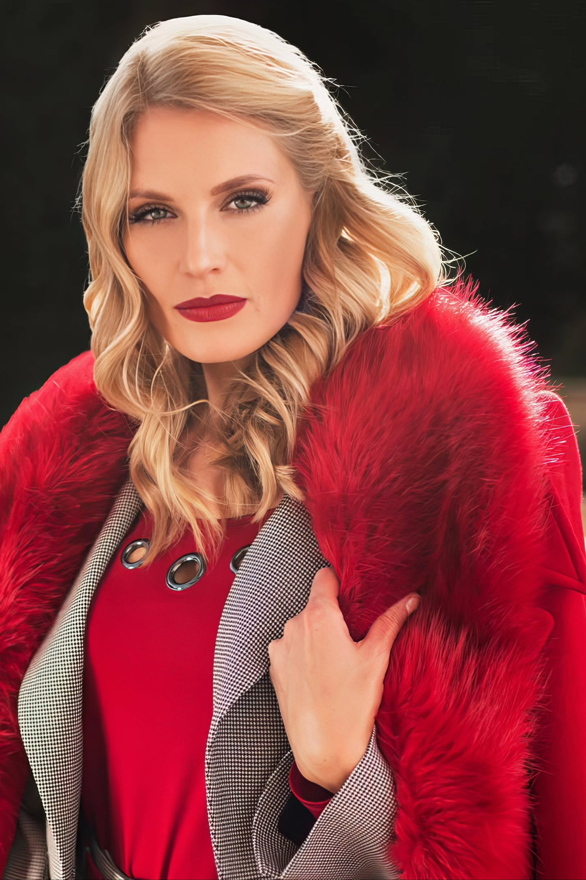 Woman wearing a red Luna Fashion House coat with a fur collar outdoors