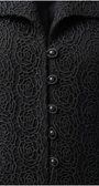 Close-up of a black textured garment with floral patterns and buttons.