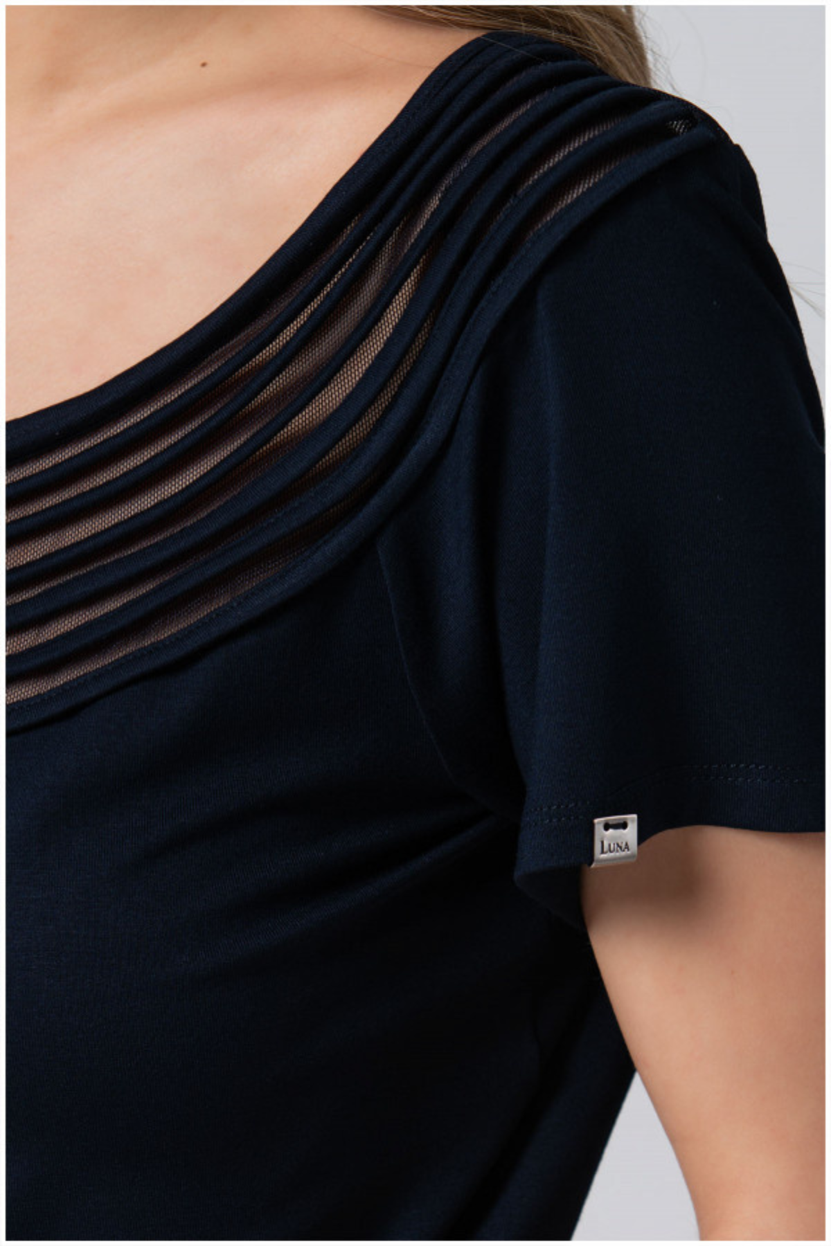 Navy blue dress with sheer overlay on a plain background